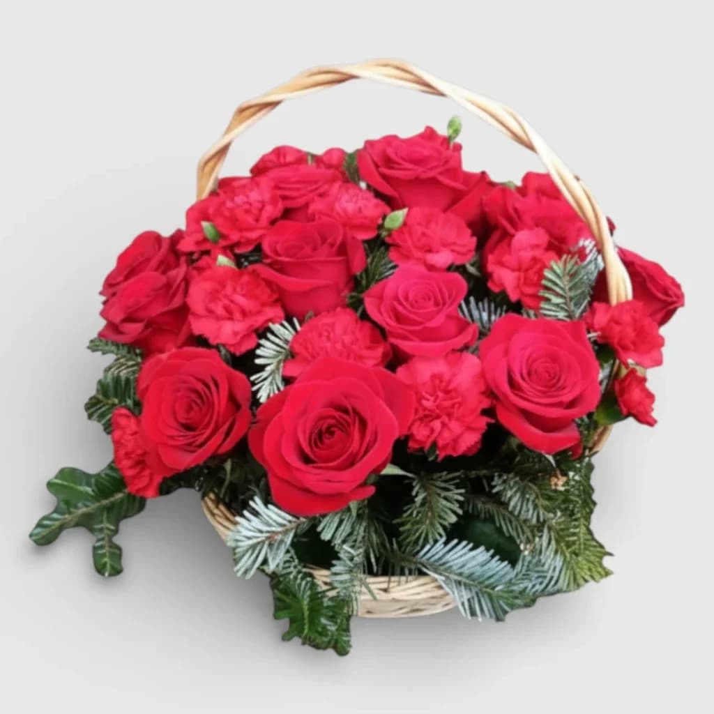 Flower arrangement of roses and carnations in a basket
