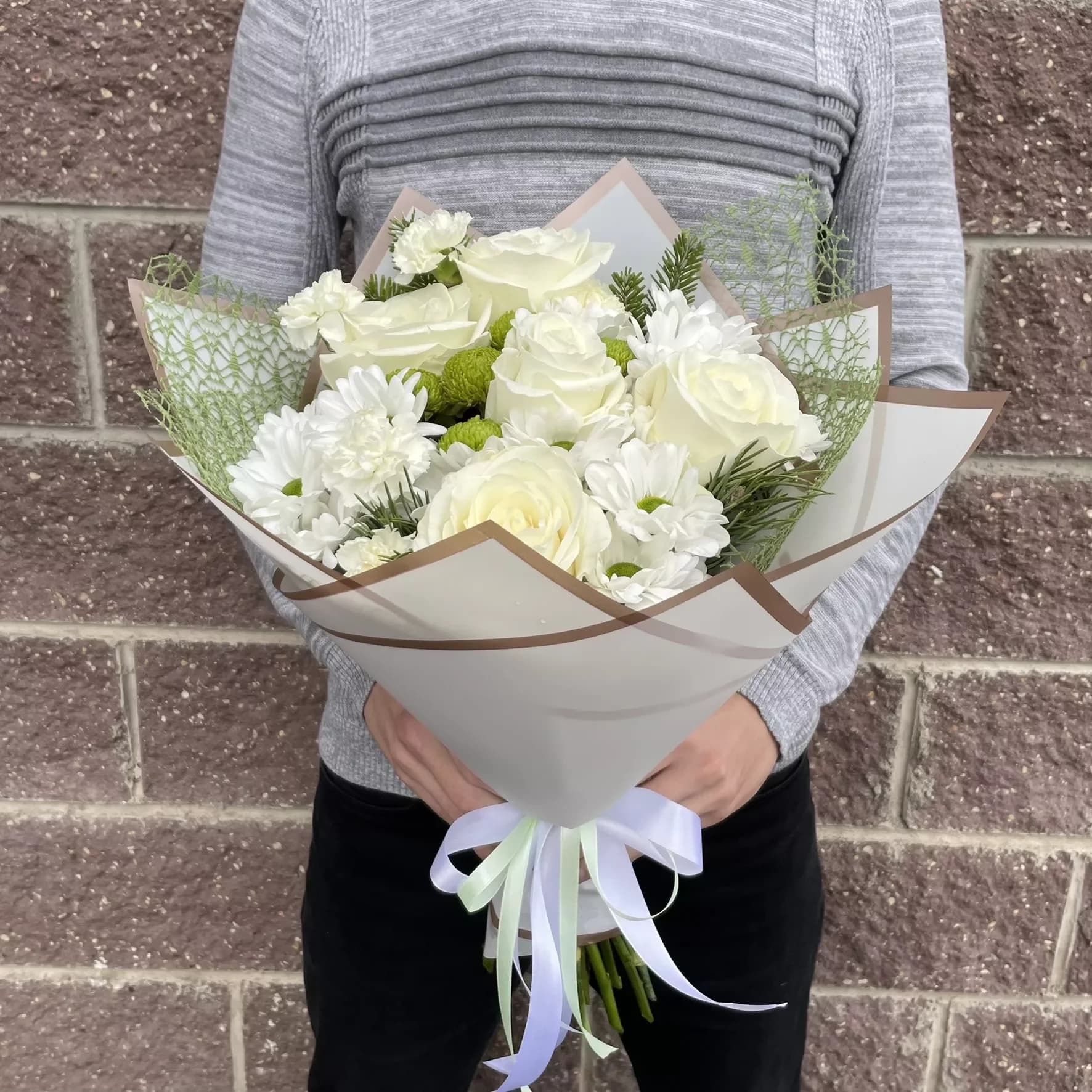Delicate bouquet of roses and chrysanthemums in white tones