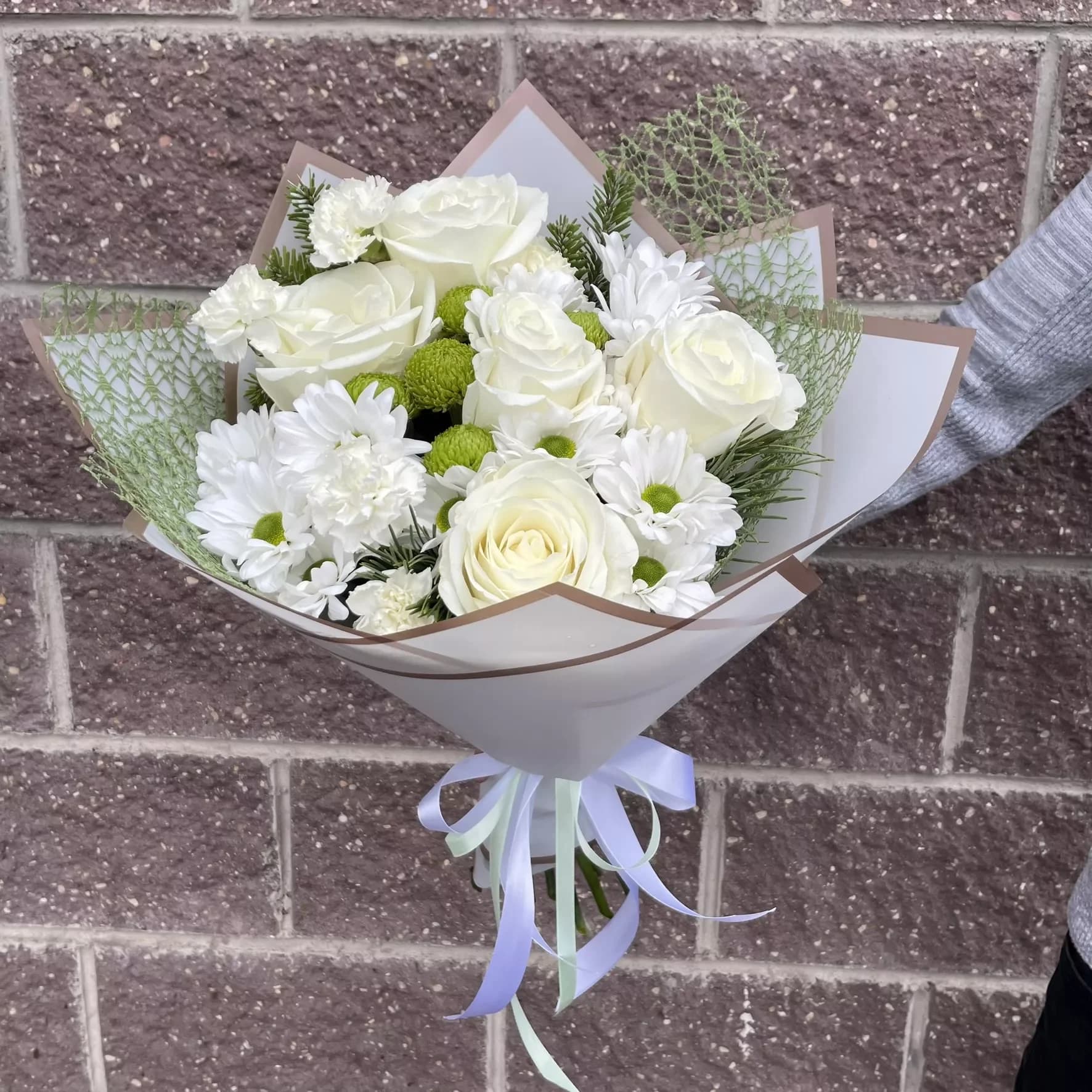 Delicate bouquet of roses and chrysanthemums in white tones