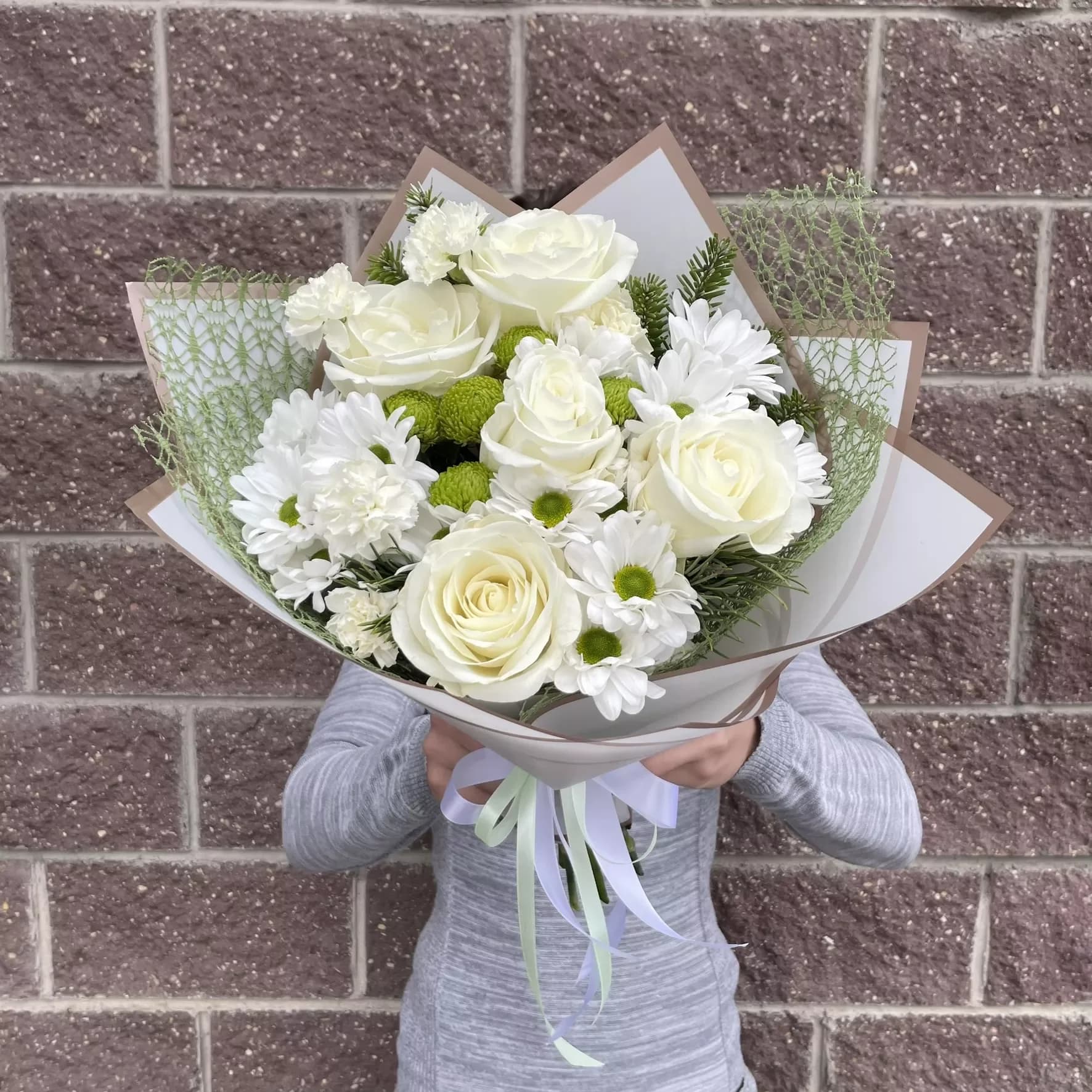 Delicate bouquet of roses and chrysanthemums in white tones
